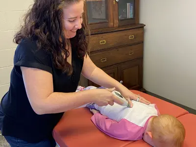 Dr. Becca, Helena, MT' best chiropractor for mothers, performing pediatric chiropractic.