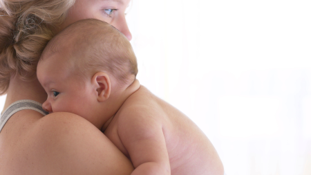 A mother and baby in Helena, MT consider the benefits of pediatric chiropractic.