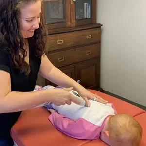 Pediatric-Chiropractic-Treatment-Helena-Mt Dr. Becca, helena, mt' best chiropractor for mothers performs an pediatric adjustment on a child.
